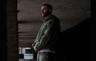 A man standing and looking thoughtfully to the left