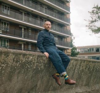 A man sitting on a wall 