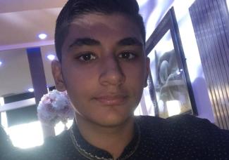 A young man looking at the camera and smiling