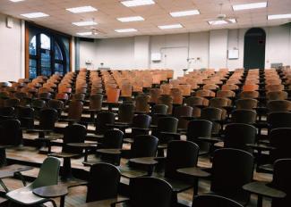 A lecture theatre full of empty chairs.