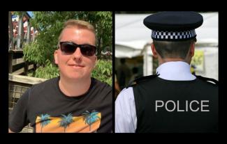 A man in sunglasses smiling for the camera, with the back of a policeman's head next to him