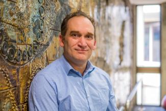 A man looking at the camera and smiling