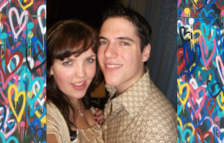 A woman and a man posing together, surrounded by graffiti hearts.