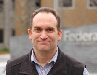 A man looking at the camera and smiling