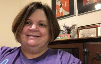 A woman looking at the camera and smiling