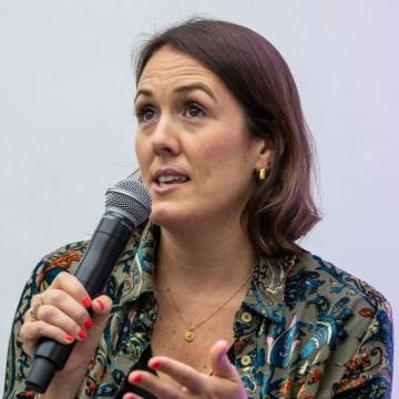 A woman speaking into a microphone