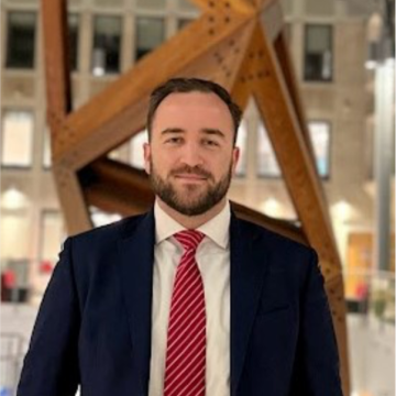 A man in a suit, smiling