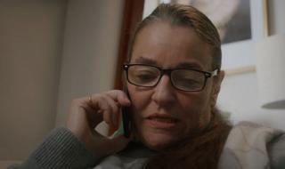 A woman speaking into a telephone