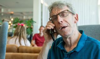 A man speaking into a telephone