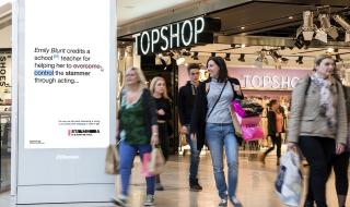 A digital advertisement board in a busy shopping centre