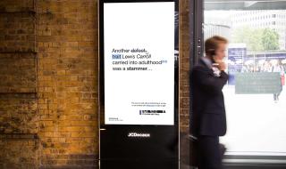 A digital advertisement board in a busy train station