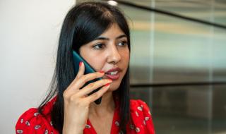 A woman speaking into a phone