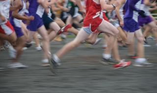 Runners in a sponsored run, from their necks down.
