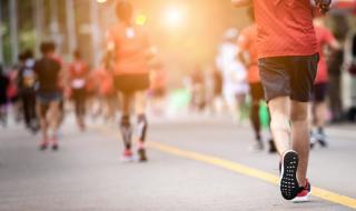 The backs of people as they run in a sponsored running event