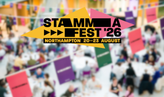 A logo saying 'STAMMAFest 2026' against a blurred picture of people seated at tables in a conference setting