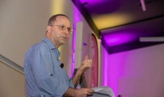 A man at a lecturn, doing public speaking