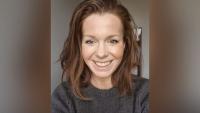 A woman looking off camera and smiling