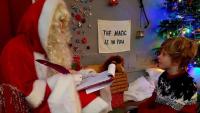 A young boy meeting Father Christmas