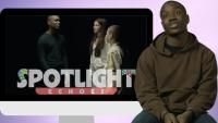 A man sitting on a stool, next to a screen showing the same man speaking with a woman and a boy. On the screen is the title 'Spotlight Echoes'