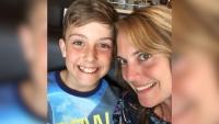 A mother and son, both smiling