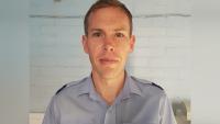 A man in a uniform looking at the camera