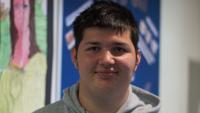 A young man smiling