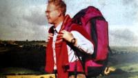 A man out on a hike, wearing a rucksack
