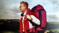 A man out on a hike, wearing a rucksack