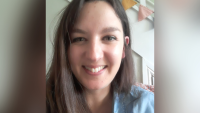 A woman looking at the camera and smiling