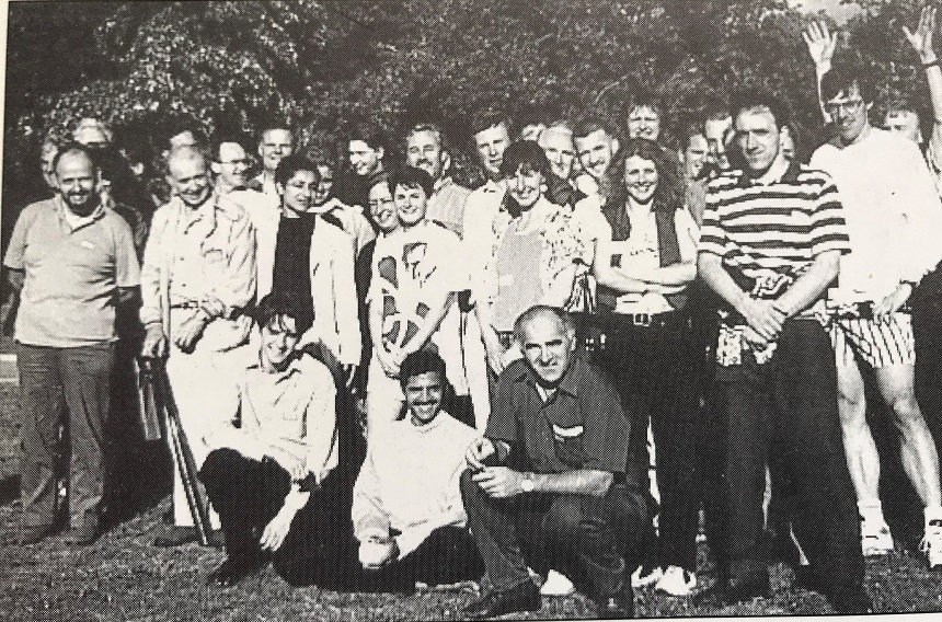 A group of people standing and kneeling, looking at the camera