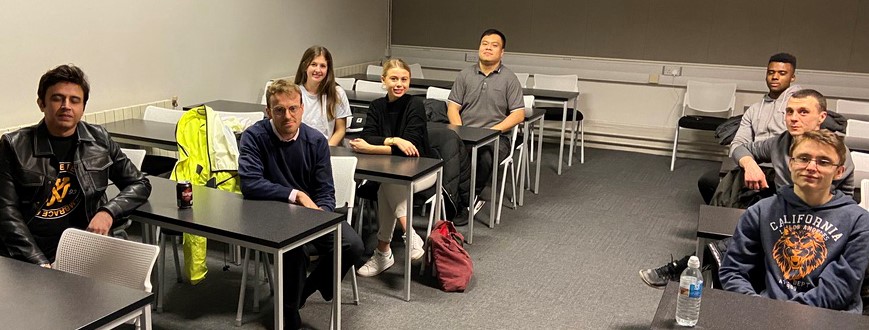 Members of the Manchester group meetings, seated and looking at the camera