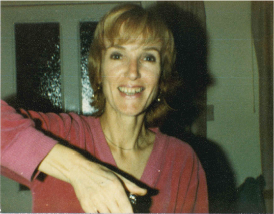 A old photograph of a woman smiling at the camera