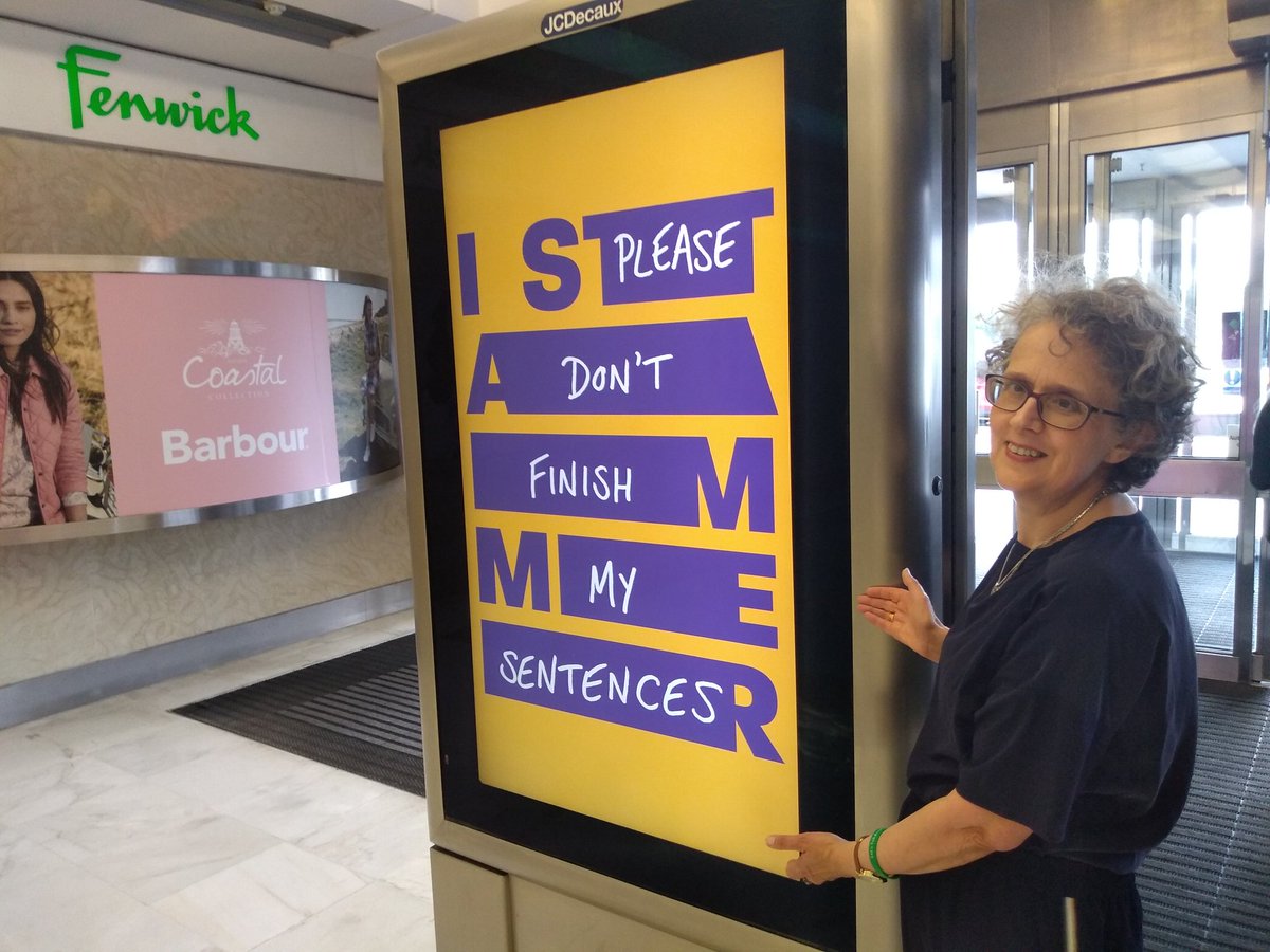 Christine, beside one of our posters, 2019