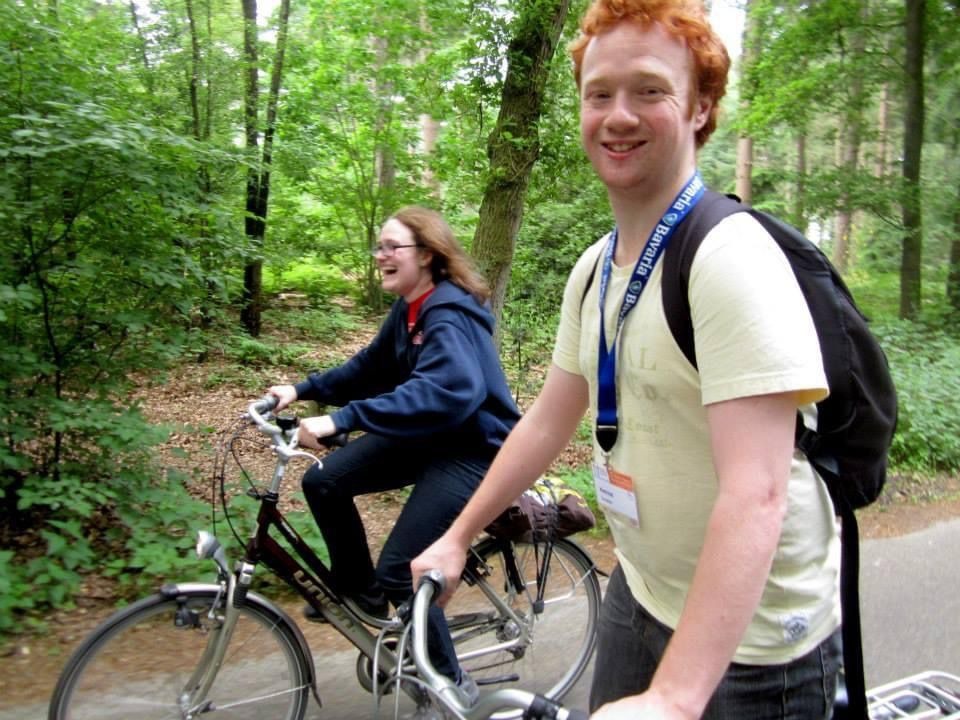 A man and a woman riding a bike