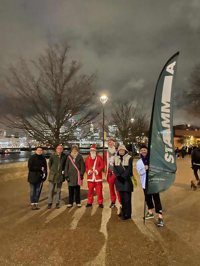 A group of people standing next to a banner