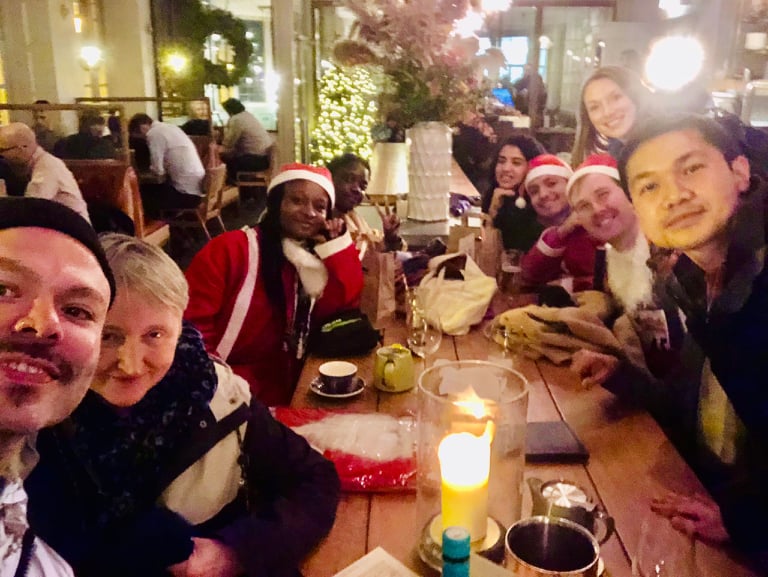 A group of people in a pub looking at the camera