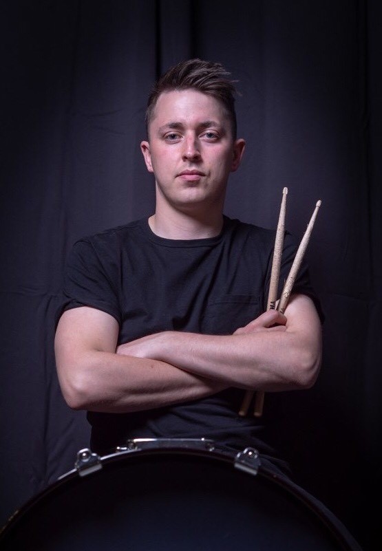 The article author, Conor Moore with drumsticks