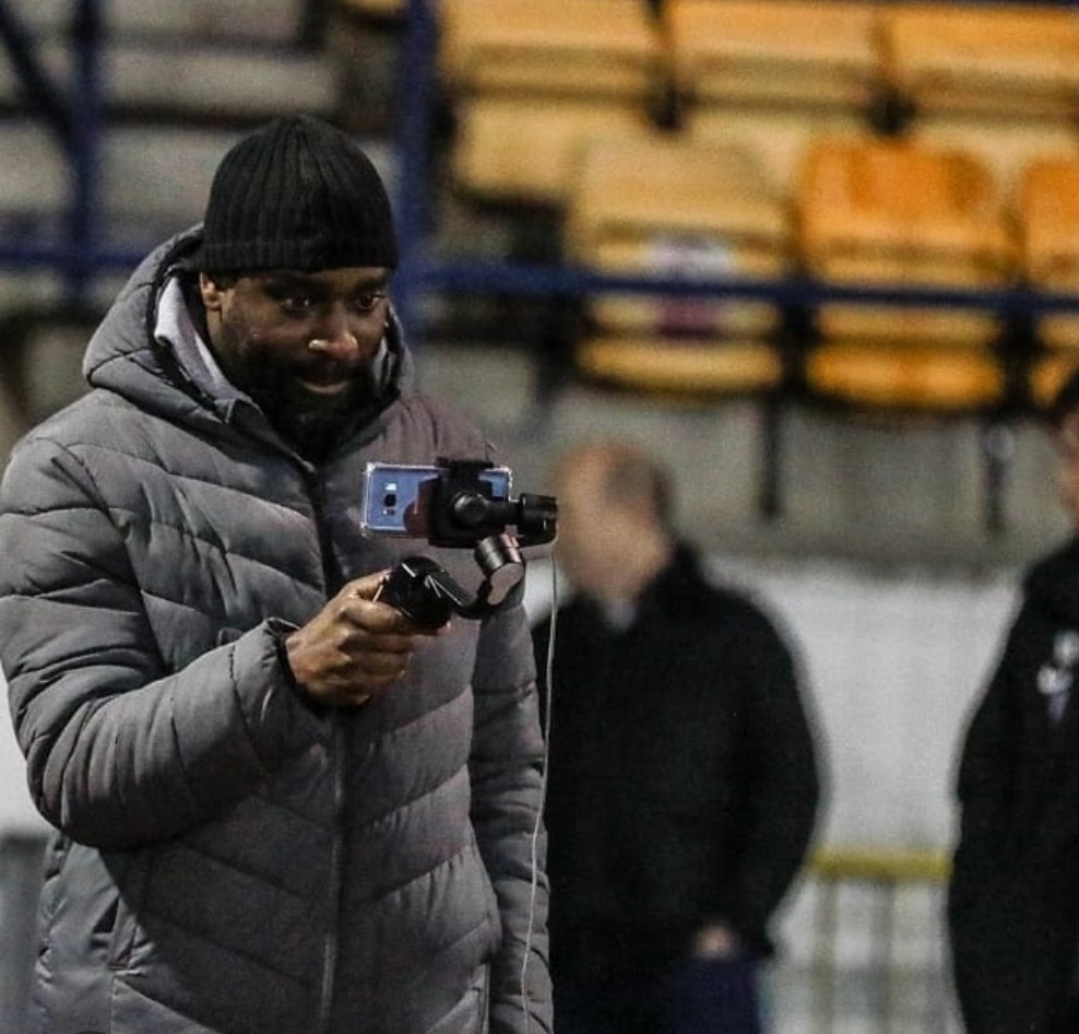 The author, Tobrise, filming at a football match